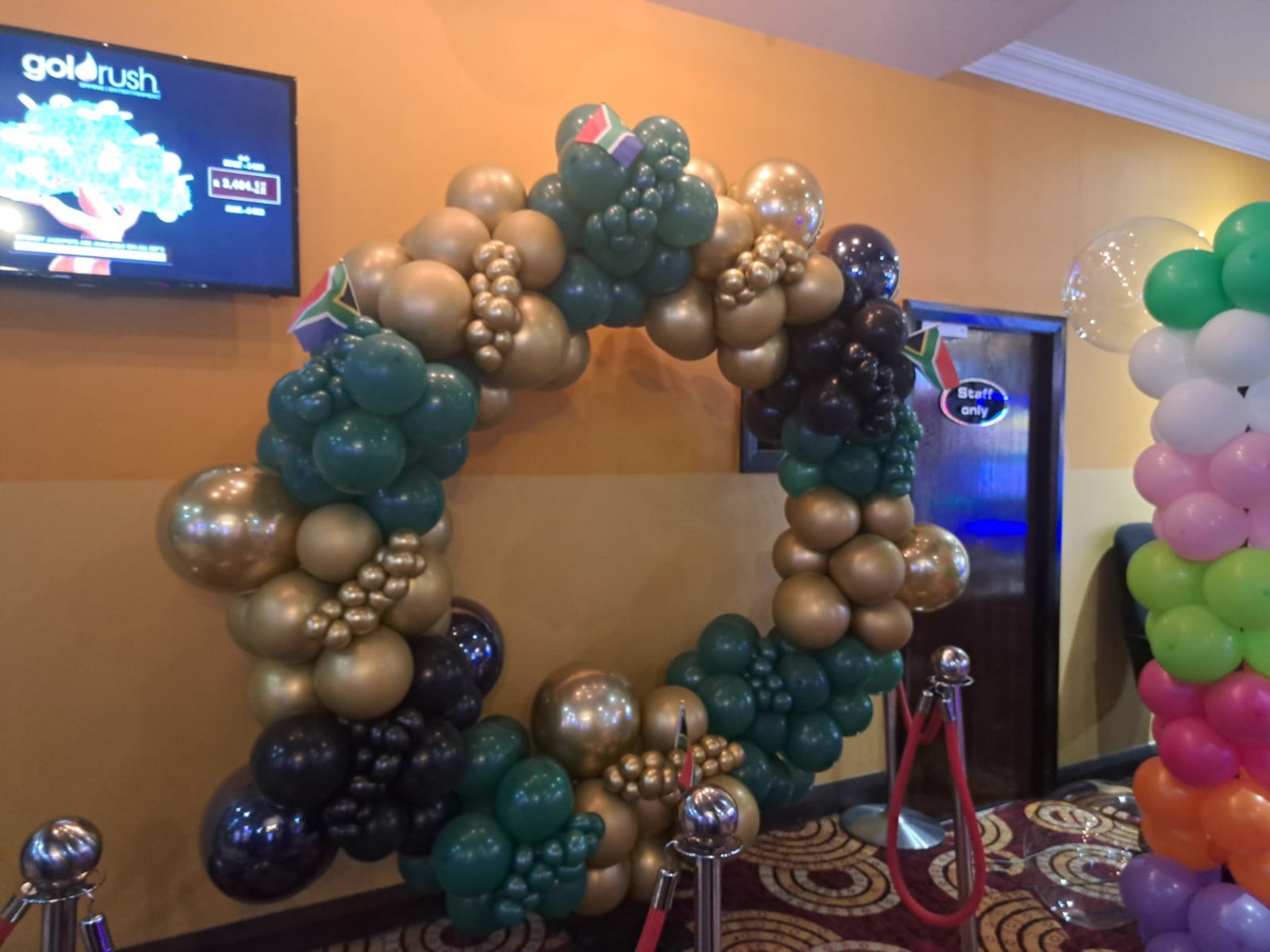 Green and gold balloon arch